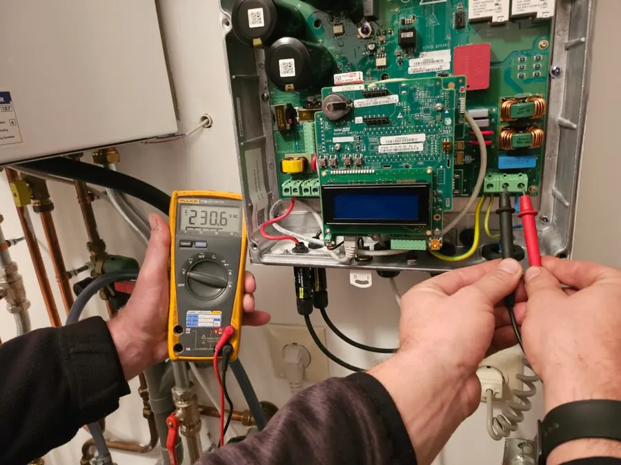 Monteur meet een omvormer door tijdens een controle